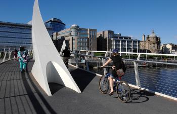 Cyclist riding over a bridge